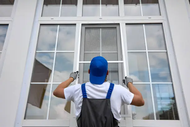 Crew replacing aging front windows on a suburban Orland Park family home