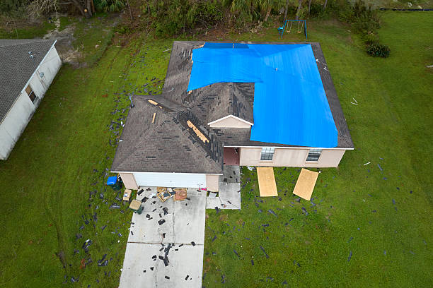Roof Storm Damage Repair in Caledonia - WI crew replacing wind-torn shingles near a roof valley