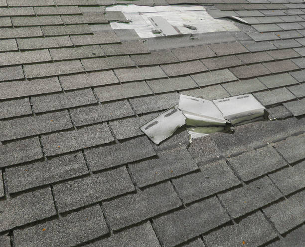 Crew repairing storm-damaged shingles on suburban Orland Park two-story home