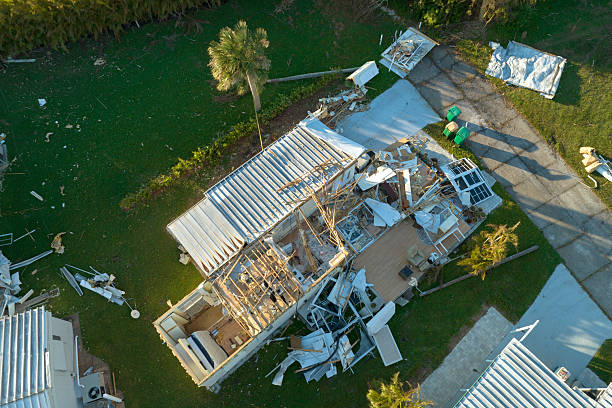 Roofers replacing storm-damaged shingles on a suburban Schaumburg home after hail